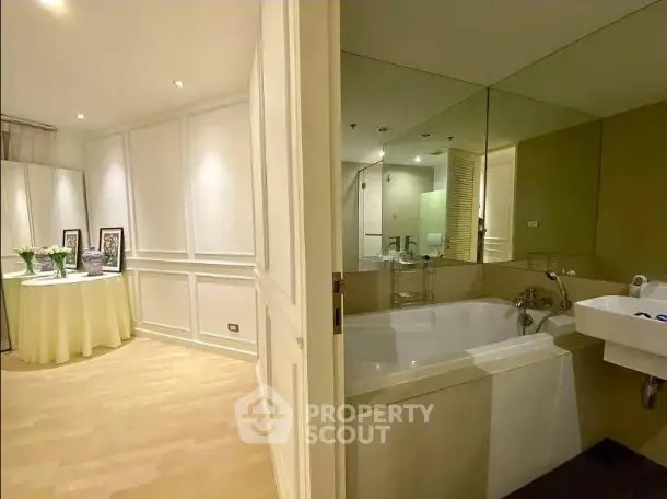 Elegant bathroom with large bathtub and stylish decor in modern apartment.