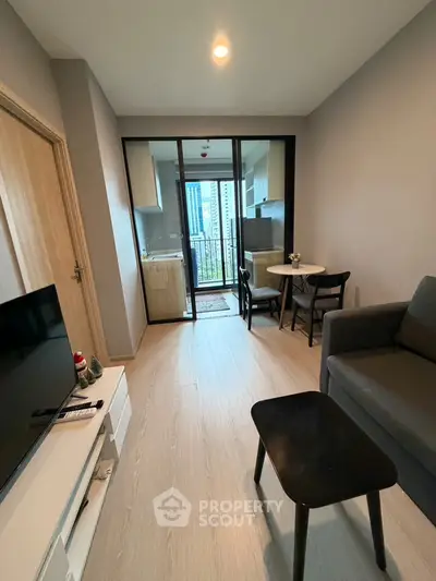 Modern living room with open layout and balcony view in urban apartment