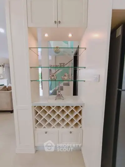 Elegant built-in shelving with wine rack in modern living space