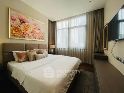 Luxurious bedroom with elegant decor and large window offering natural light.