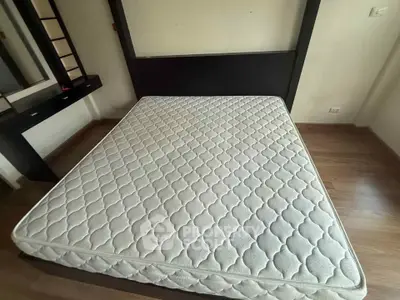 Spacious bedroom with modern bed and hardwood flooring