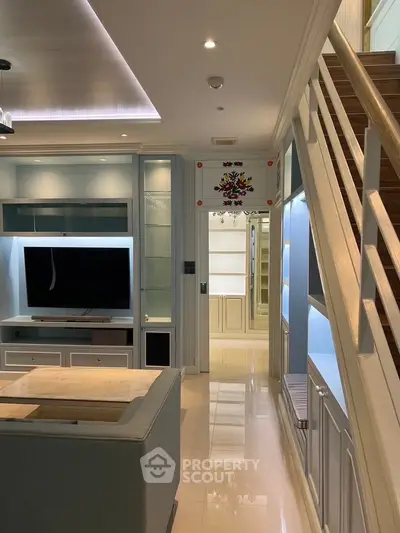 Luxurious modern living room with sleek design and staircase, perfect for stylish urban living.