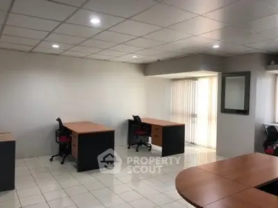 Spacious office space with modern desks and ample natural light, ideal for productivity and collaboration.