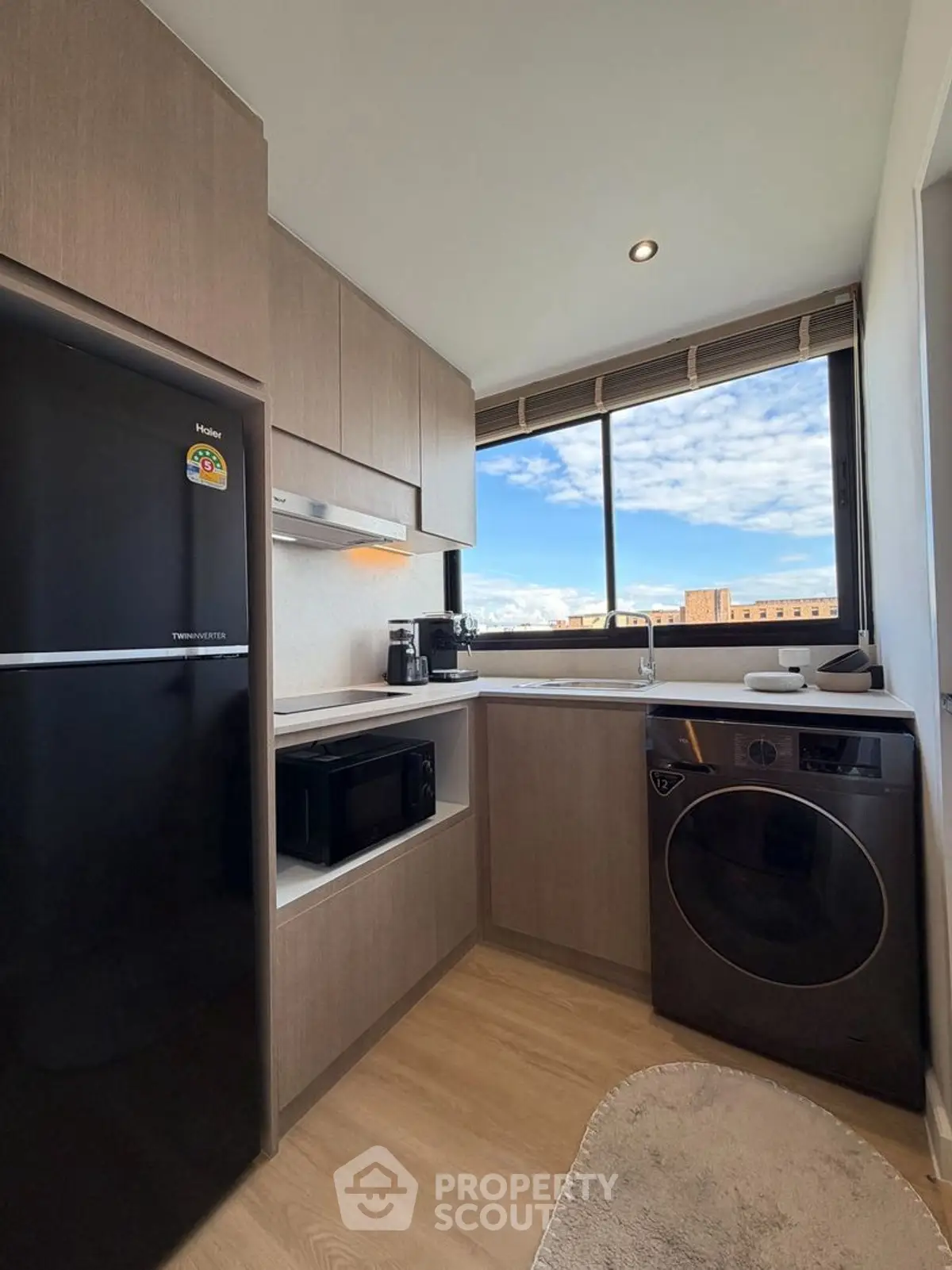 Modern kitchen with sleek appliances and large window view
