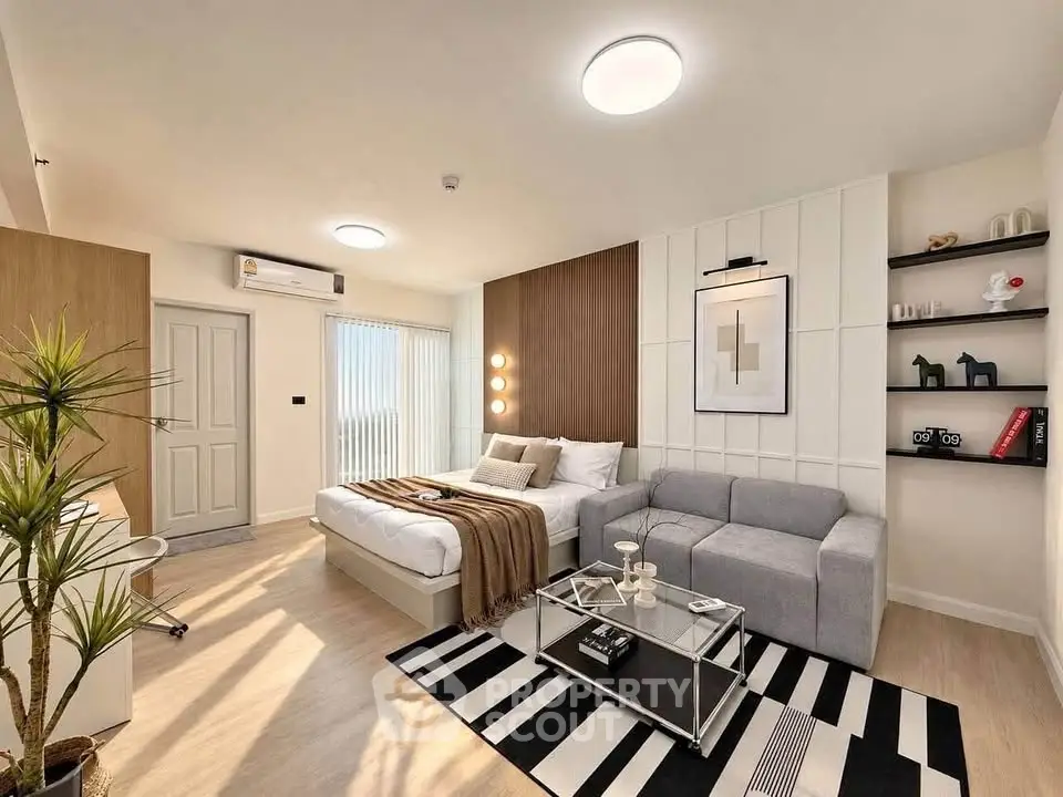 Modern bedroom with stylish decor, cozy seating area, and natural light.