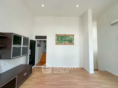 Spacious living room with modern furniture and wooden flooring, ideal for contemporary living.