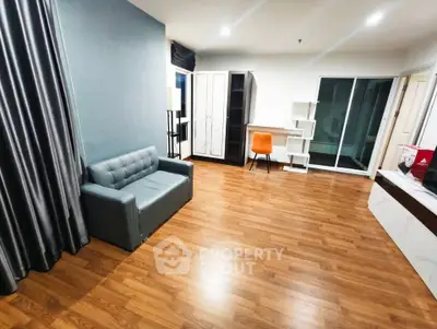 Spacious modern living room with wooden flooring and stylish furniture