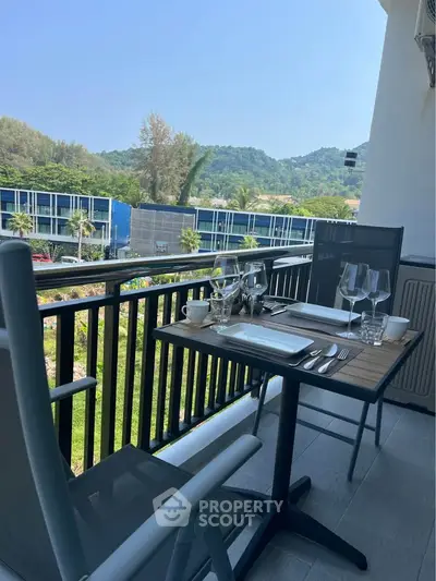 Charming balcony with mountain view, perfect for outdoor dining and relaxation.