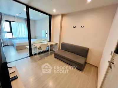 Modern studio apartment with sleek design and ample natural light, featuring a cozy living area and stylish bedroom.