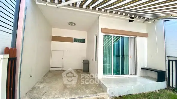 Modern exterior with sliding glass doors and covered patio area.