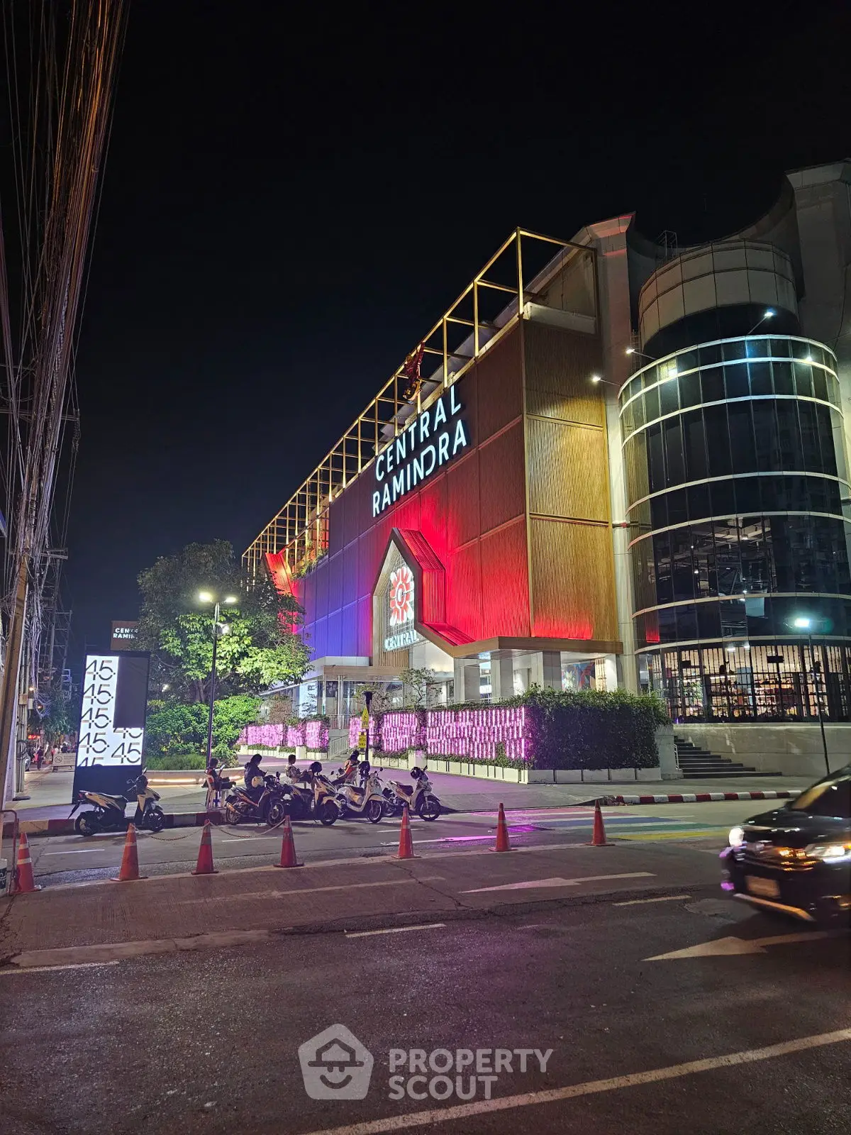 Stunning night view of Central Ramindra shopping complex with vibrant lights and modern architecture.