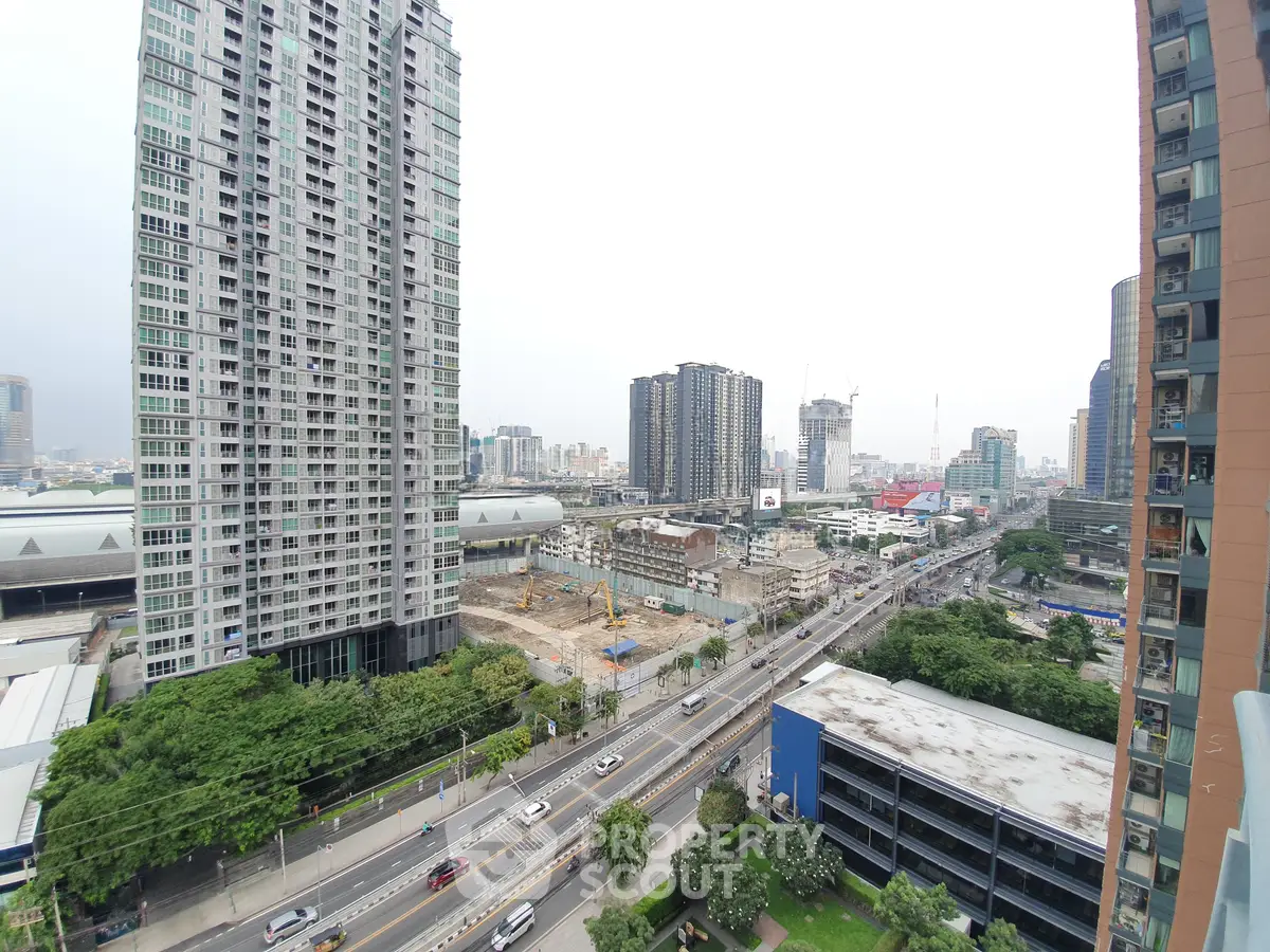 Stunning urban cityscape view from a high-rise balcony, showcasing modern skyscrapers and bustling streets.