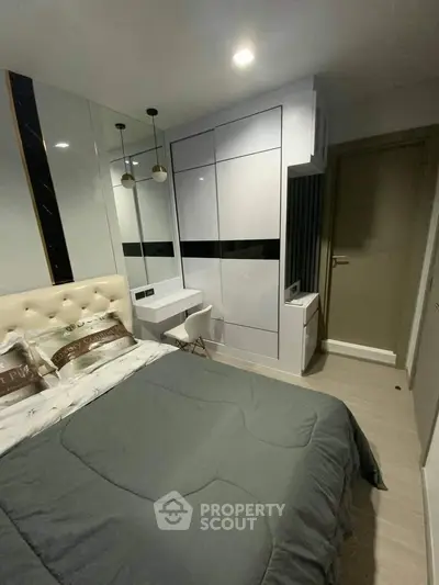 Modern bedroom with sleek wardrobe and cozy bed in stylish apartment.