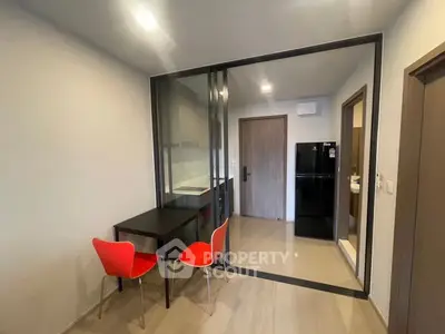 Modern compact kitchen with glass partition and dining area