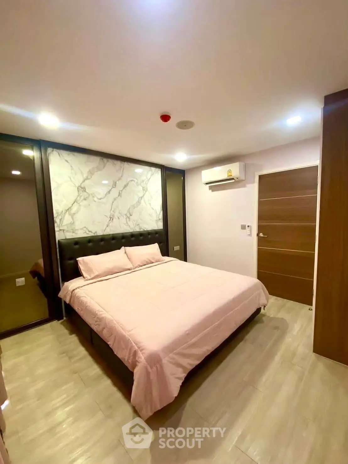 Modern bedroom with marble accent wall and air conditioning