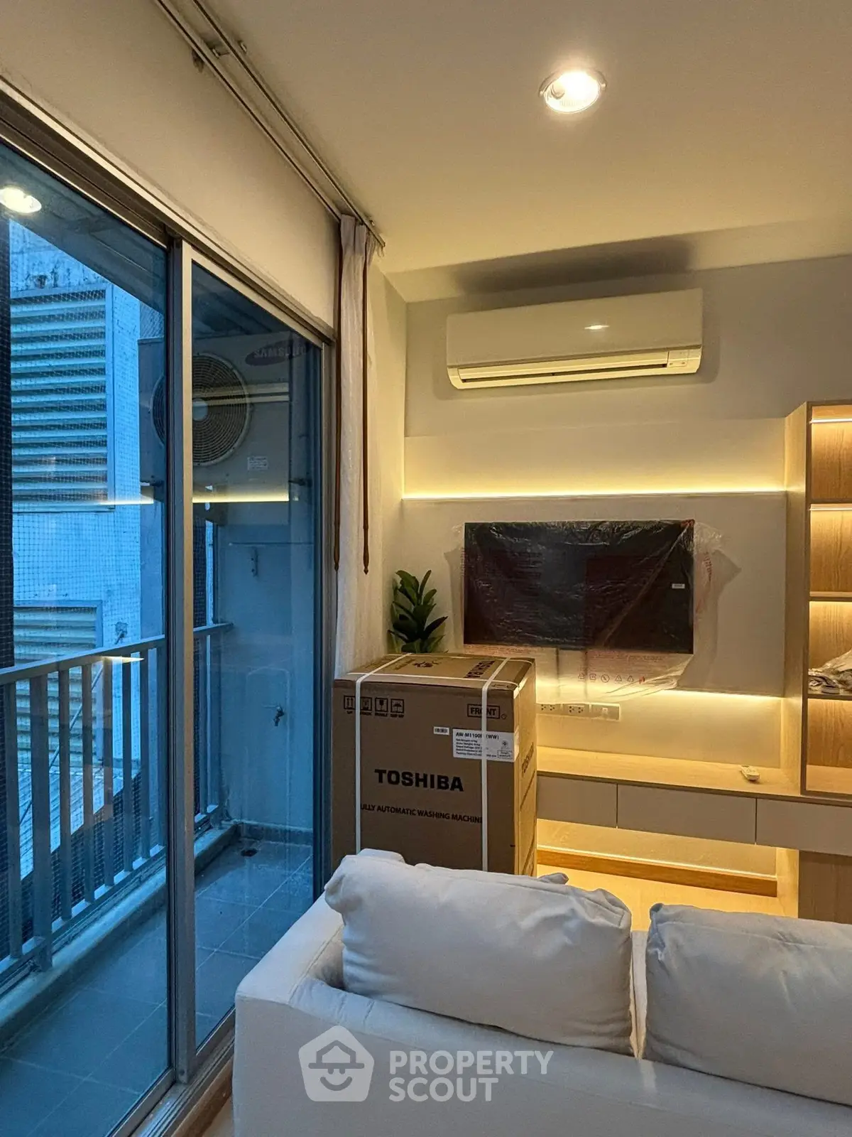 Modern living room with balcony and new Toshiba washing machine