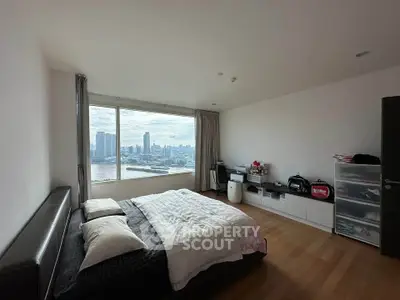 Spacious bedroom with stunning city view and modern decor