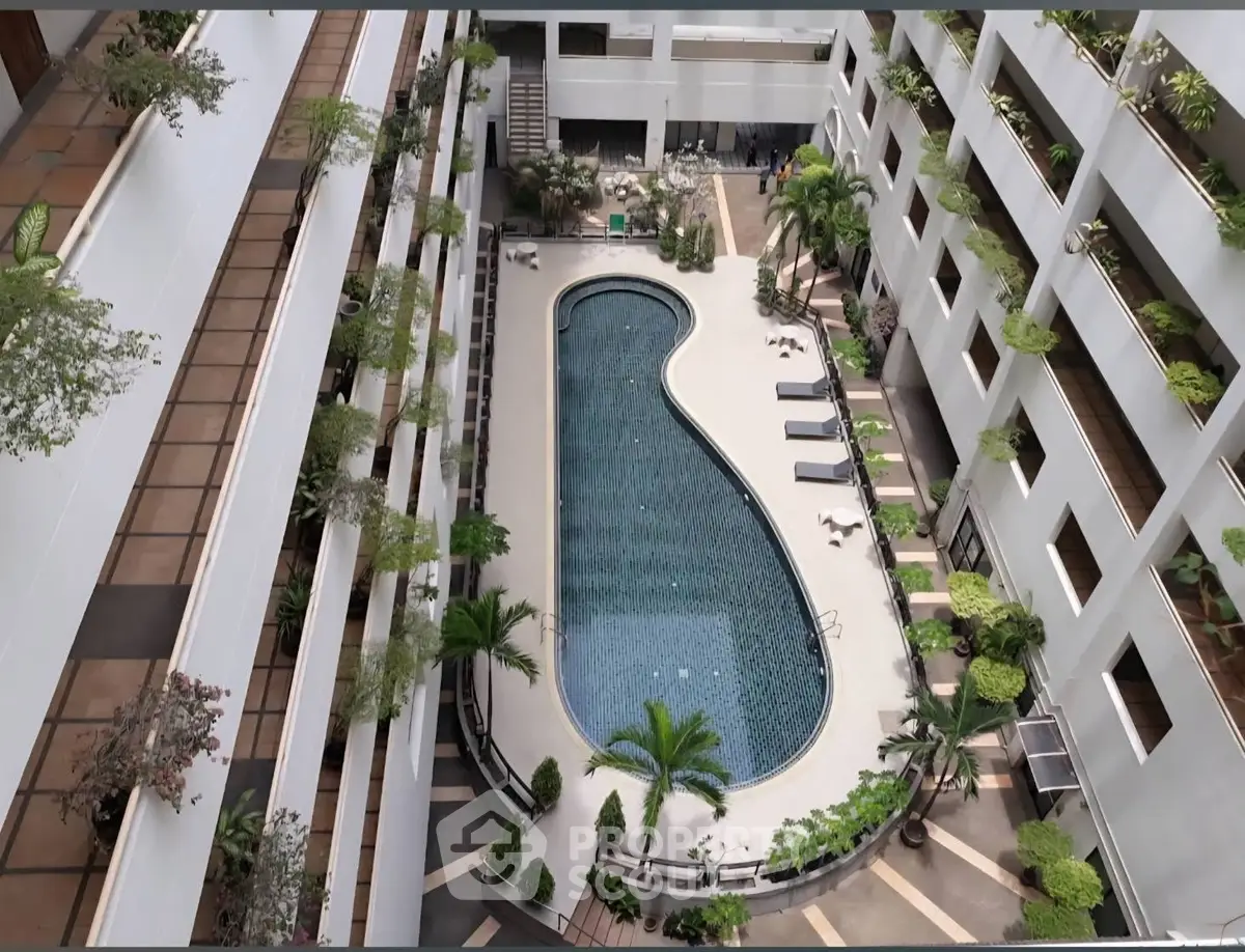Luxurious apartment complex with central pool and lush greenery, perfect for relaxation and leisure.