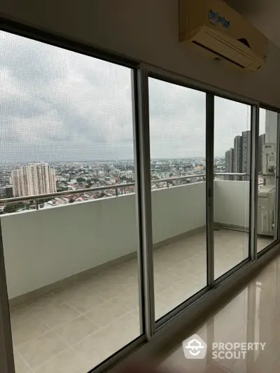 Spacious balcony with stunning city view from high-rise apartment