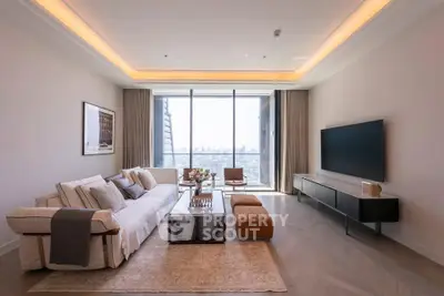 Luxurious living room with modern decor and stunning city view through large windows.