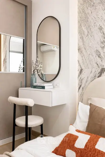 Stylish bedroom corner with modern decor and elegant mirror
