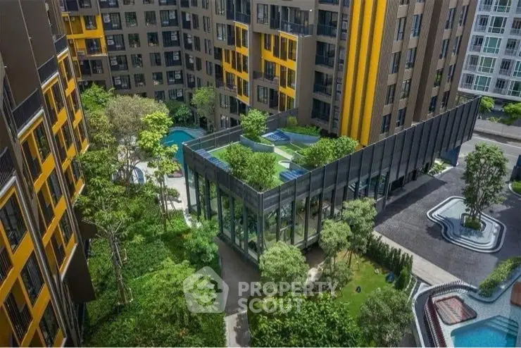 Modern apartment complex with lush gardens and pool view