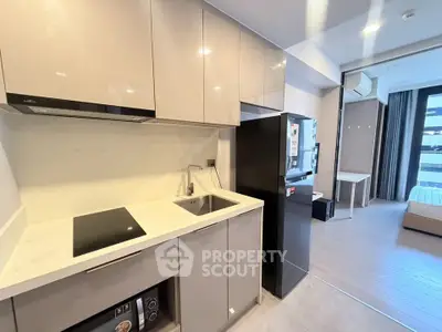 Modern kitchen with sleek cabinets and appliances in a stylish apartment