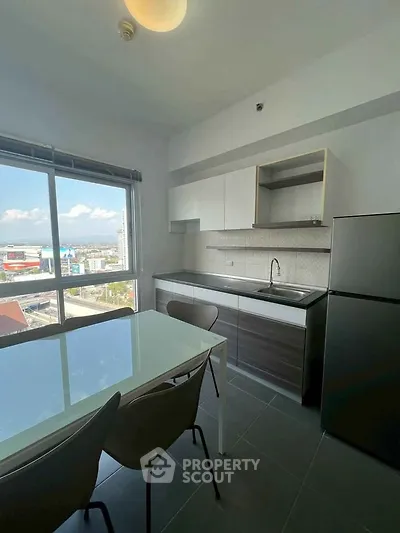 Modern kitchen with dining area and city view from large window