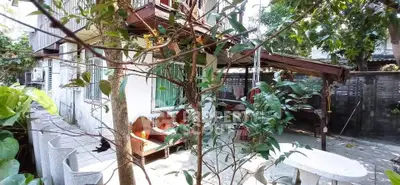 Charming outdoor space with seating area and lush greenery, perfect for relaxation and entertaining.