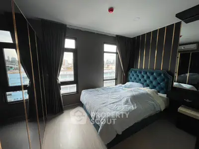 Luxurious bedroom with city view, featuring elegant decor and plush bedding.