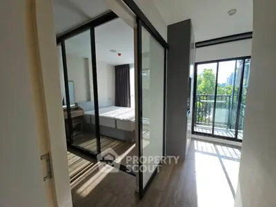 Modern apartment with glass-walled bedroom and balcony view