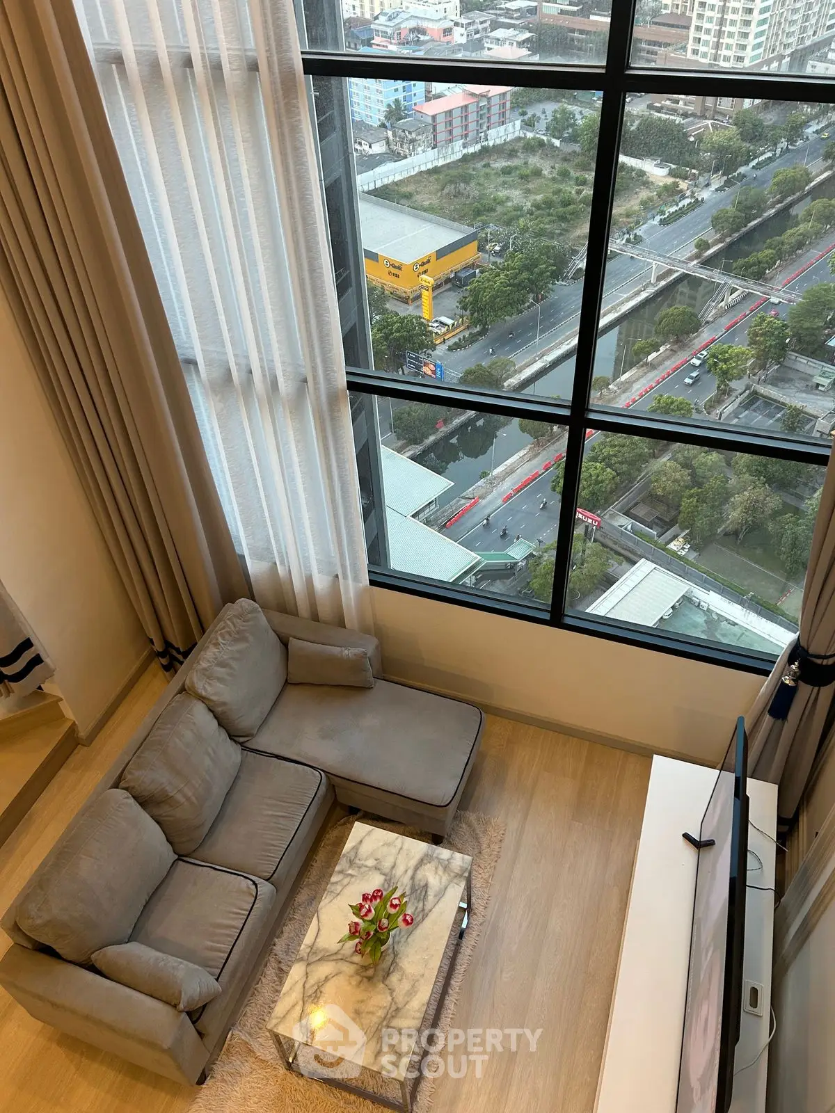 Stunning high-rise living room with panoramic city view and elegant decor