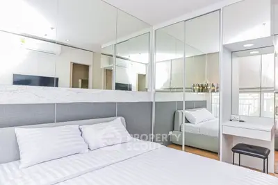 Modern bedroom with mirrored wardrobe and stylish decor