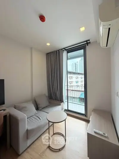 Modern living room with cozy sofa and city view balcony in urban apartment.