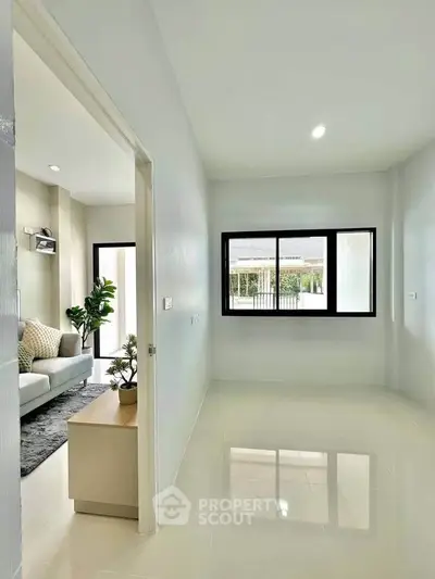 Bright and spacious living area with modern decor and large windows for natural light.