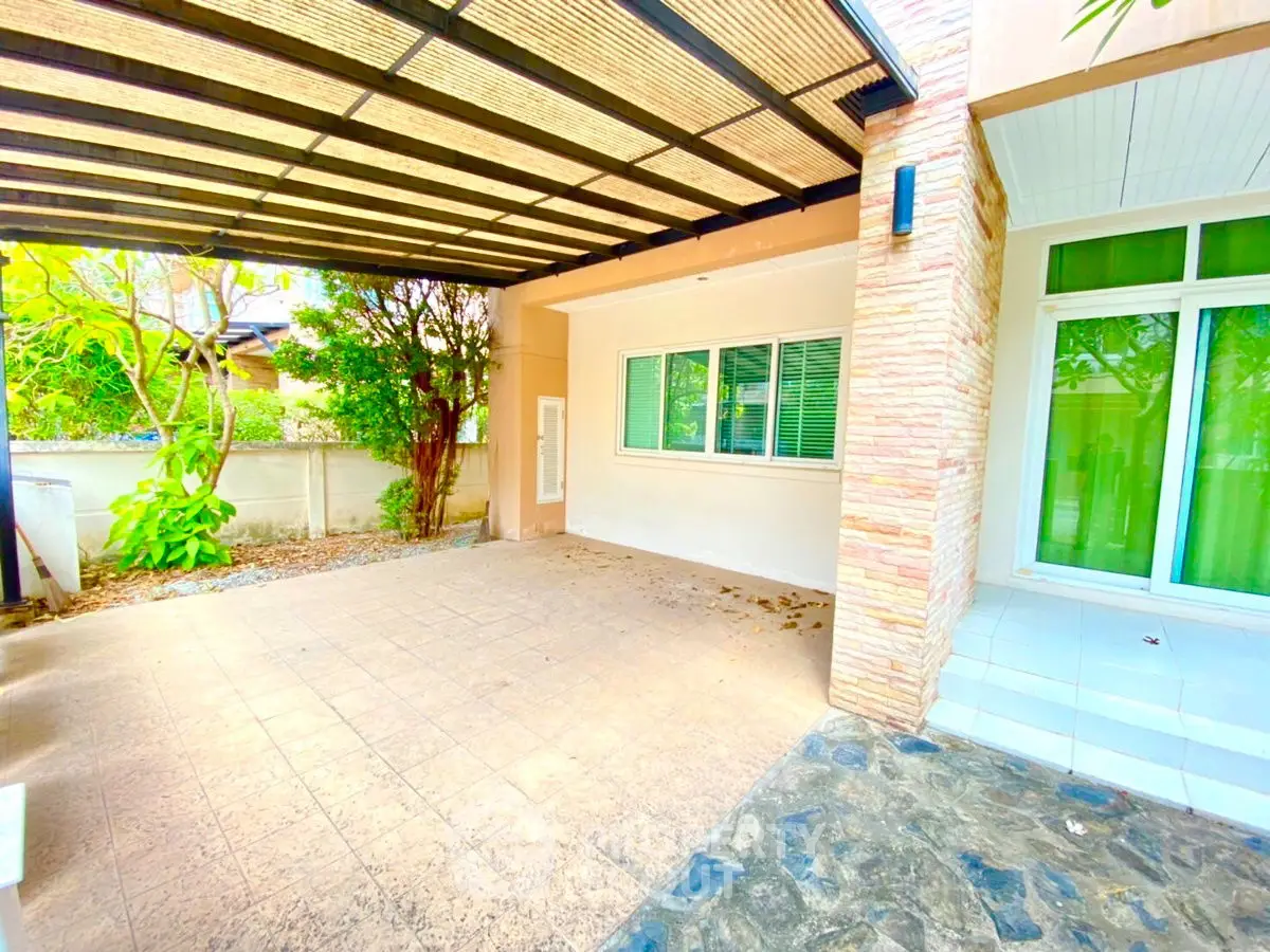 Spacious covered patio with modern design and natural light, perfect for outdoor relaxation.