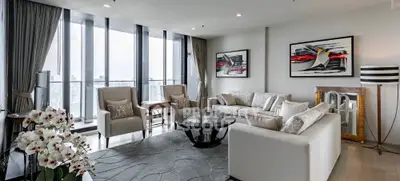 Luxurious modern living room with panoramic city views and elegant decor.