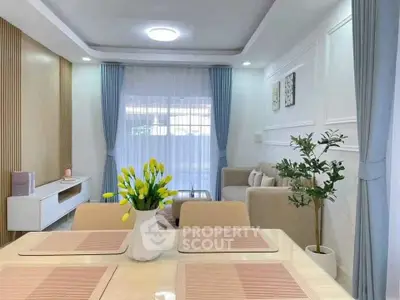 Elegant living room with modern decor and natural light, featuring stylish furniture and tasteful accents.
