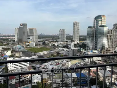 Stunning cityscape view from high-rise balcony overlooking urban skyline.