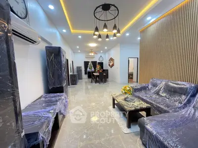 Spacious modern living room with elegant lighting and stylish furniture, perfect for family gatherings.