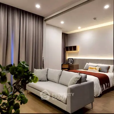 Luxurious bedroom with modern decor and cozy seating area, perfect for relaxation.