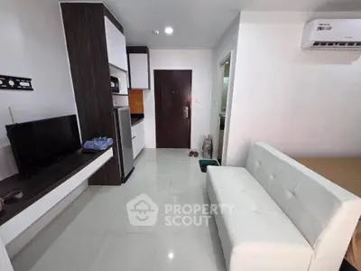 Modern studio apartment with sleek furniture and air conditioning, perfect for urban living.