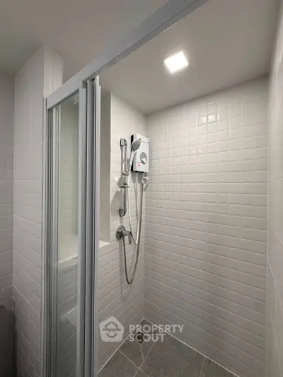 Modern bathroom with sleek shower and tiled walls