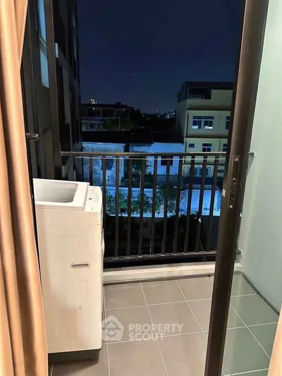 Charming balcony view with washing machine in modern apartment setting.