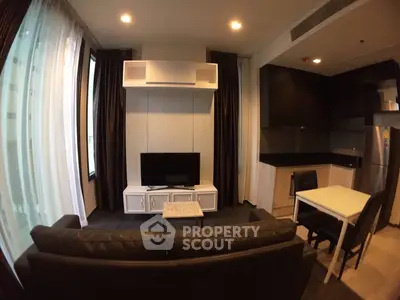 Modern living room with sleek furniture and integrated kitchen area, perfect for urban living.