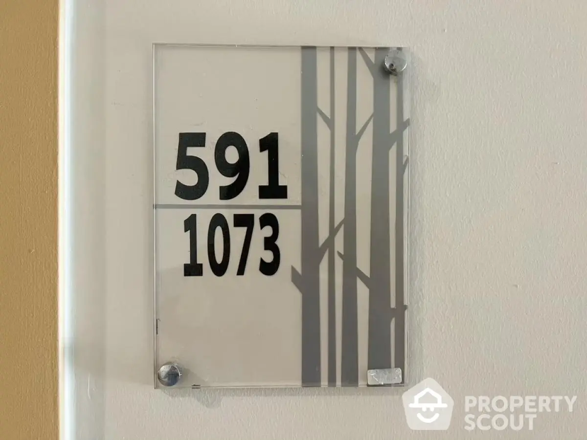 Modern apartment unit number sign with sleek design and stylish typography.