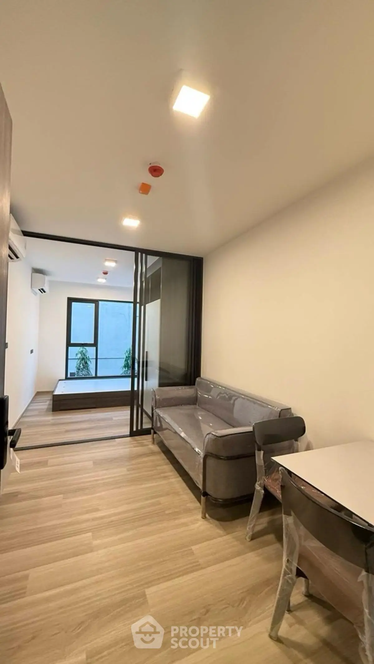 Modern living room with sleek furniture and large windows in a contemporary apartment.