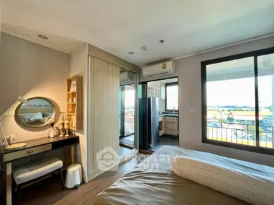Modern bedroom with balcony view and stylish decor in a cozy apartment.