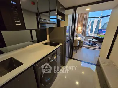 Modern apartment with sleek kitchen and spacious living room featuring city skyline view.
