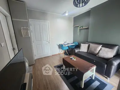 Cozy living room with modern decor and dining area, featuring a sleek sofa and stylish table.